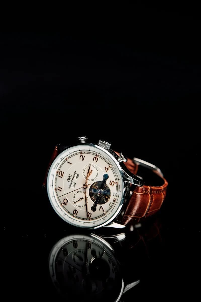 IWC Schaffhausen watch with a white dial and brown leather strap.