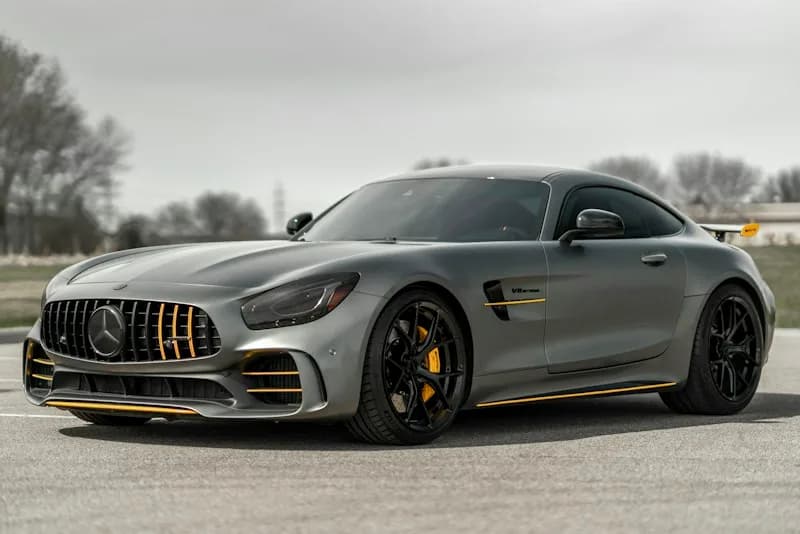 Silver Mercedes-Benz sports car parked on a road.