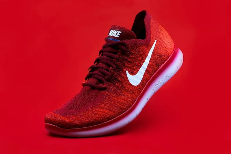 Red Nike sneaker against a red background.